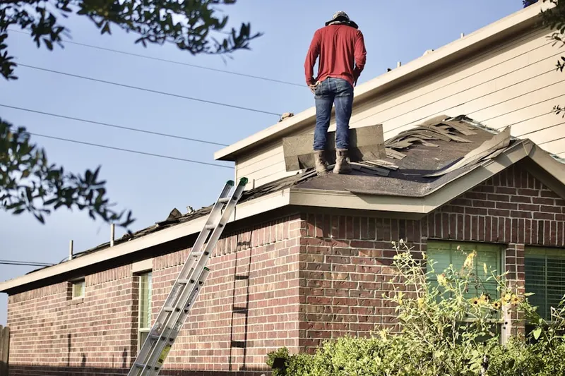Professional roofer working on a residential roof in Remington